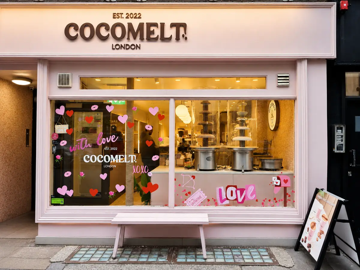 Illustrated cut vinyl decals and lettering across a dessert cafe window in London