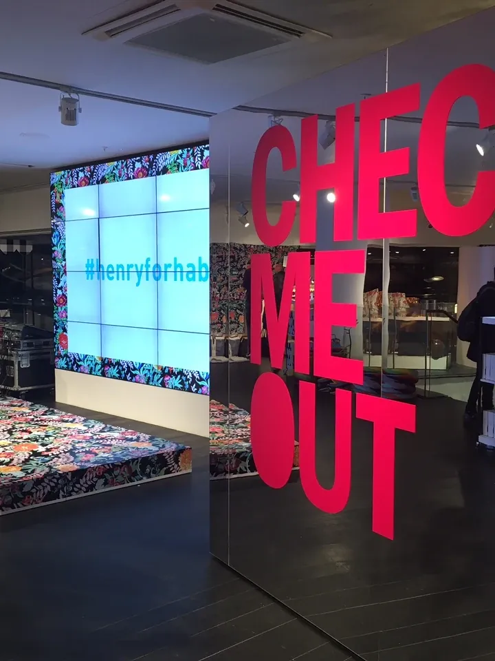 Pink cut vinyl campaign lettering applied to a mirror wall in a Habitat London store