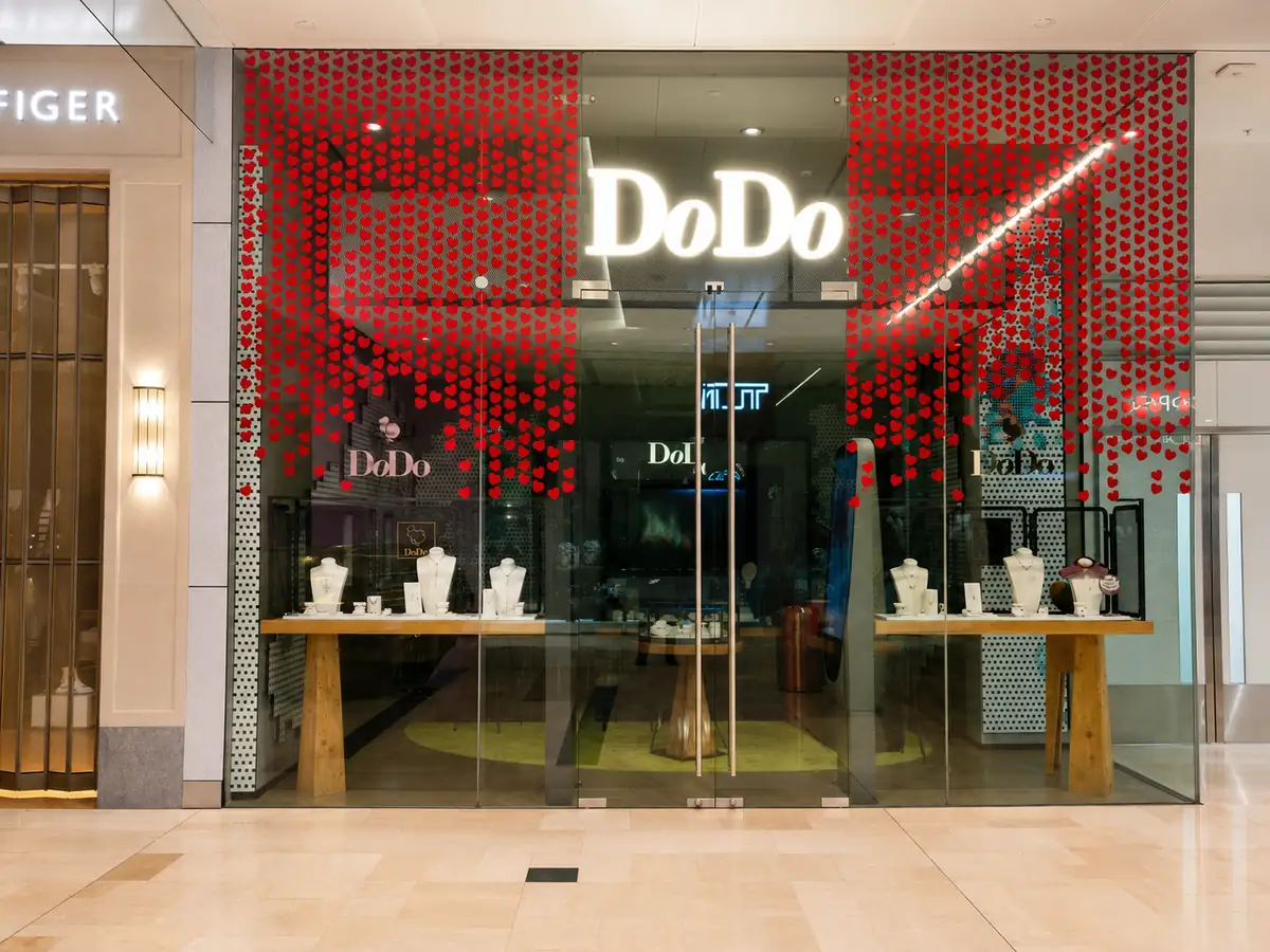 Red cut vinyl dot decals cascading across luxury jewellery store windows in a London shopping centre