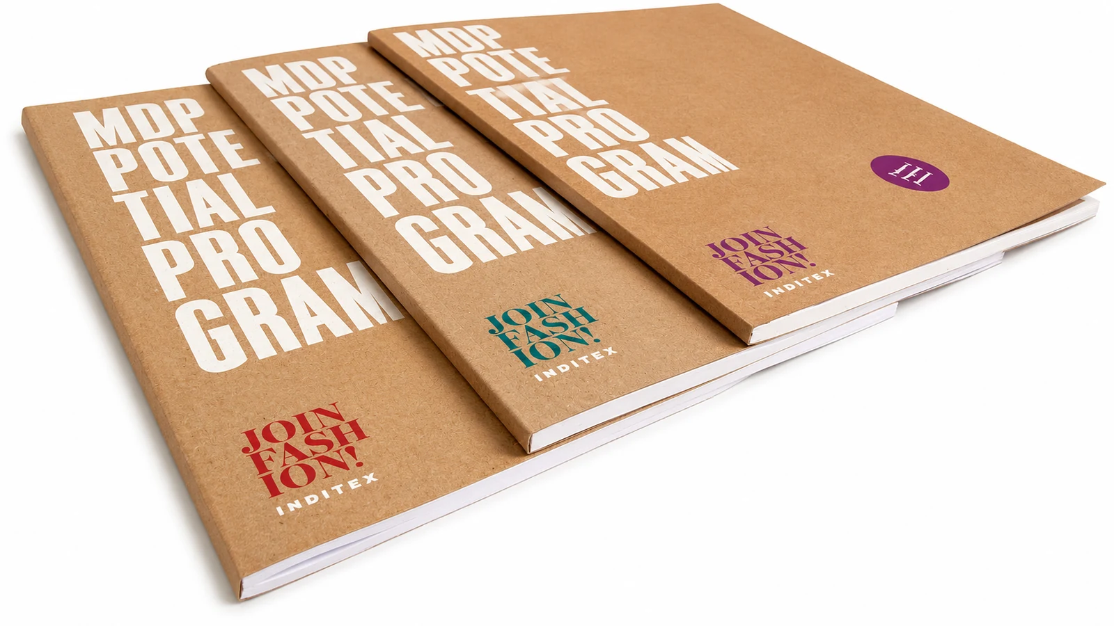 Perfect bound kraft-covered booklets stacked to show the flat square spine