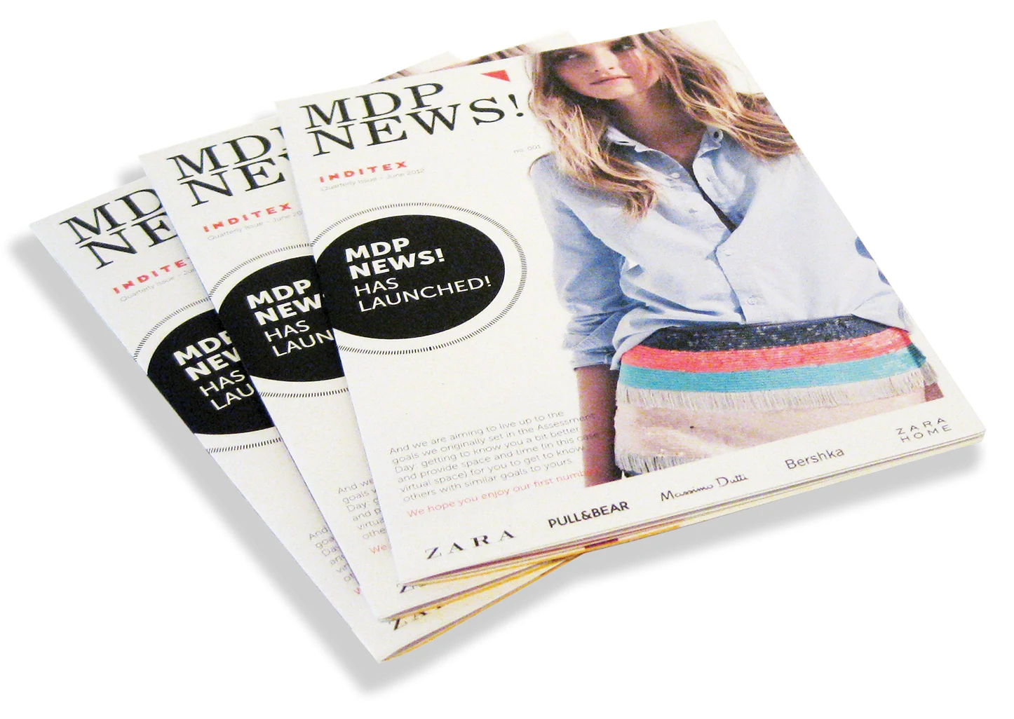 Saddle stitched magazine opened flat at the centre spread, full-colour printed
